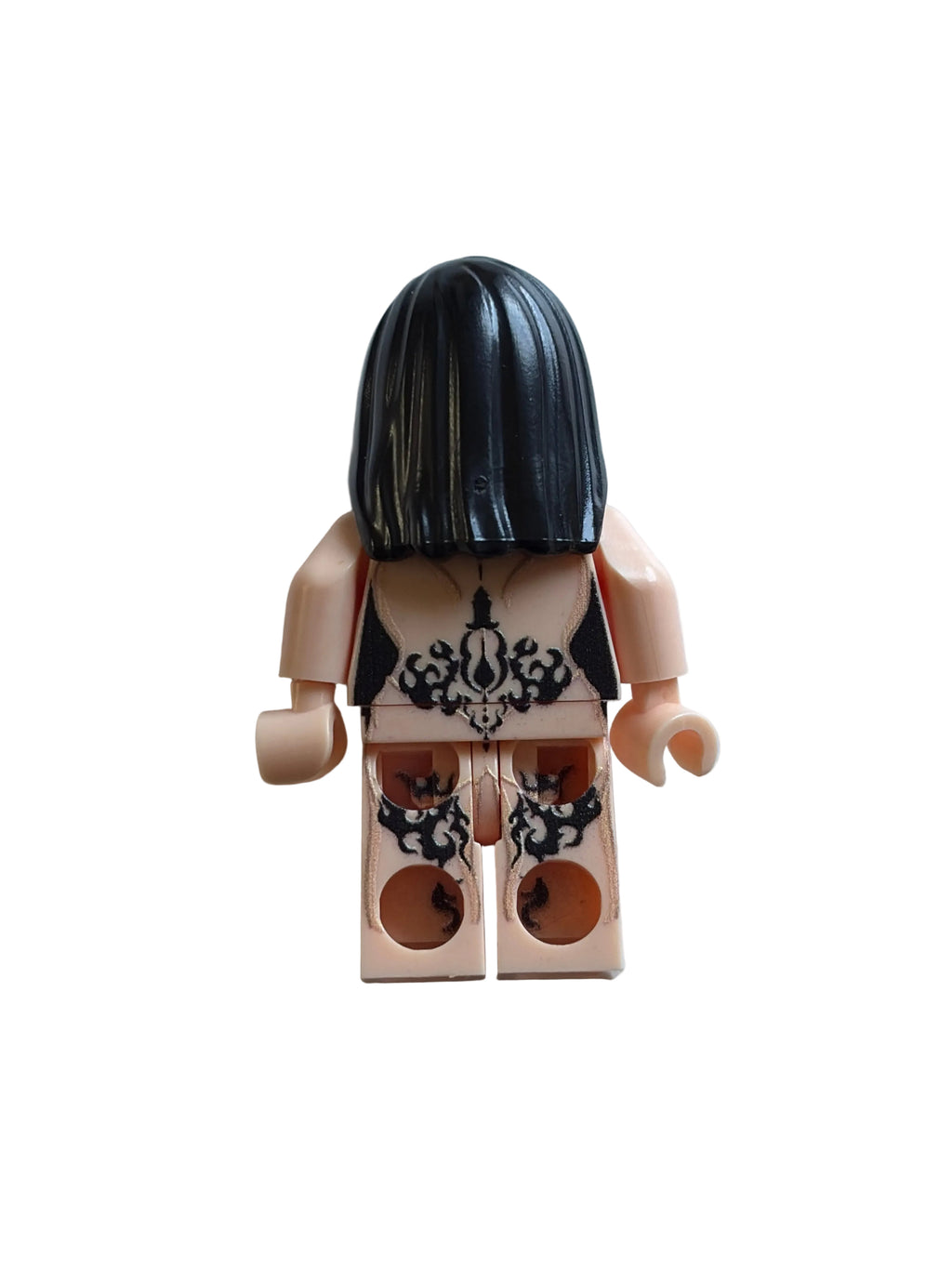 A custom-built toy minifigure torso with a black hair dome, beige skin, and a black-and-white patterned shirt, shown on a light gray background.
