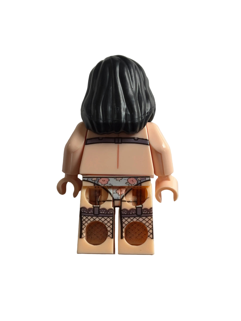 A back view of a custom LEGO minifigure with black hair, peach skin, and brown lace panties, photographed on a plain off-white background.