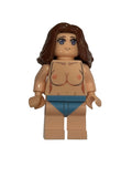 Toy figure with brown hair and blue eyes on a white background