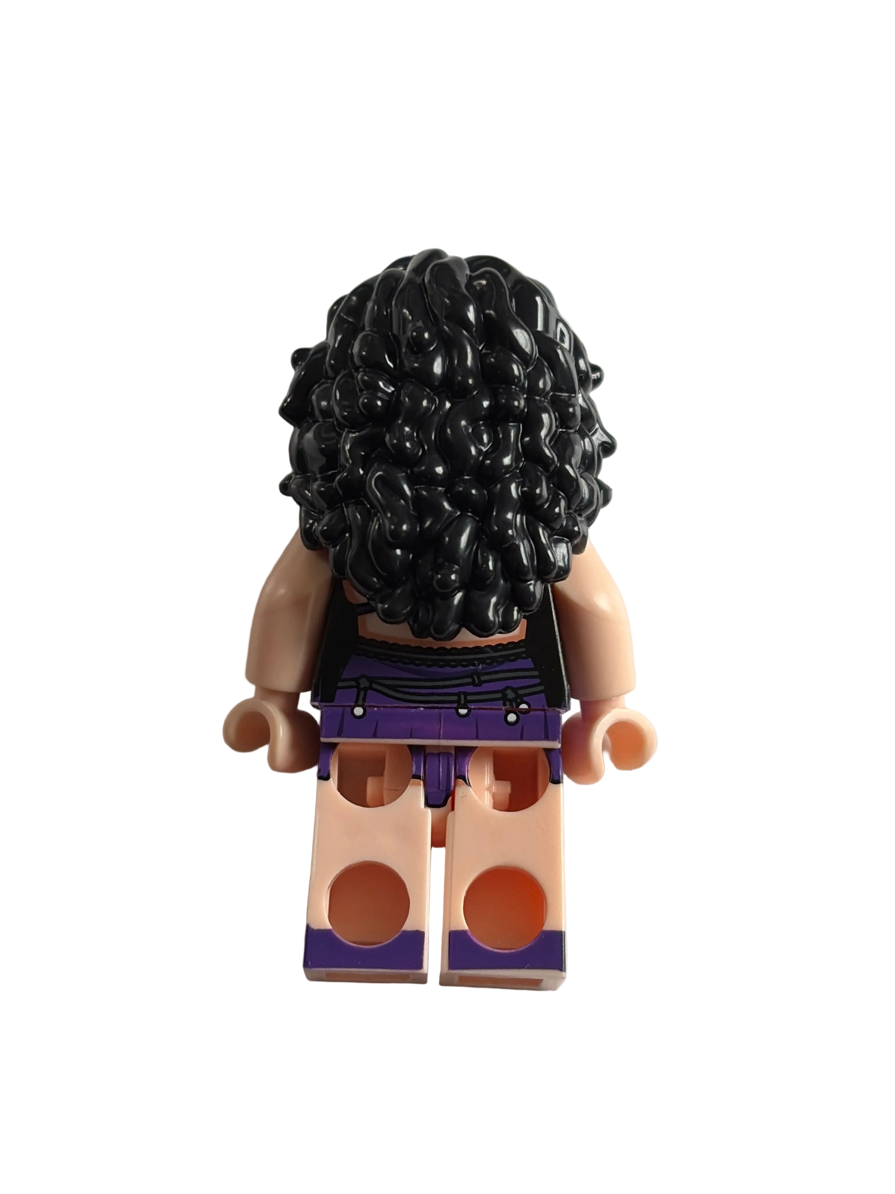 A LEGO minifigure torso with black curly hair, a purple and black top, and beige plastic legs, photographed on a plain light background.