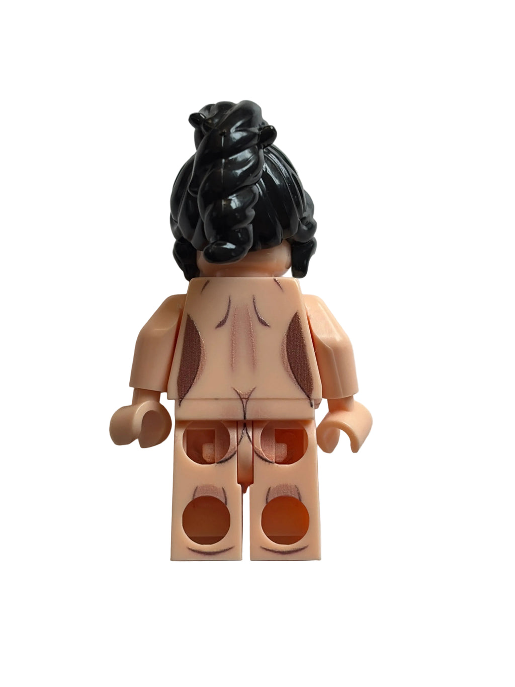 A back view of a female minifigure with black hair in a messy bun, light peach skin, and brown hair accents on her back, set against a plain light gray background.