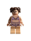 A custom LEGO minifigure of a woman with brown hair, glasses, and a beige skin tone, wearing a purple and white patterned bra and skirt set, shown on a plain light gray background.
