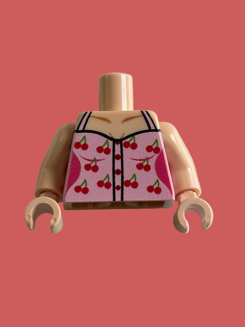 A LEGO minifigure torso piece with peach skin and a pink printed vest featuring a red cherry pattern, shown on a light gray background.