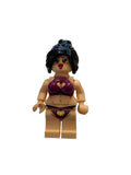 A custom-built toy minifigure with a beige body, dark blue-black hair, and a purple bikini with red heart details, standing against a plain off-white background.