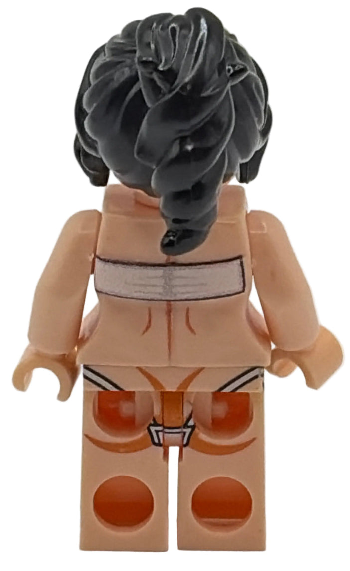 Toy figure with a black hairdo and beige body on a white background