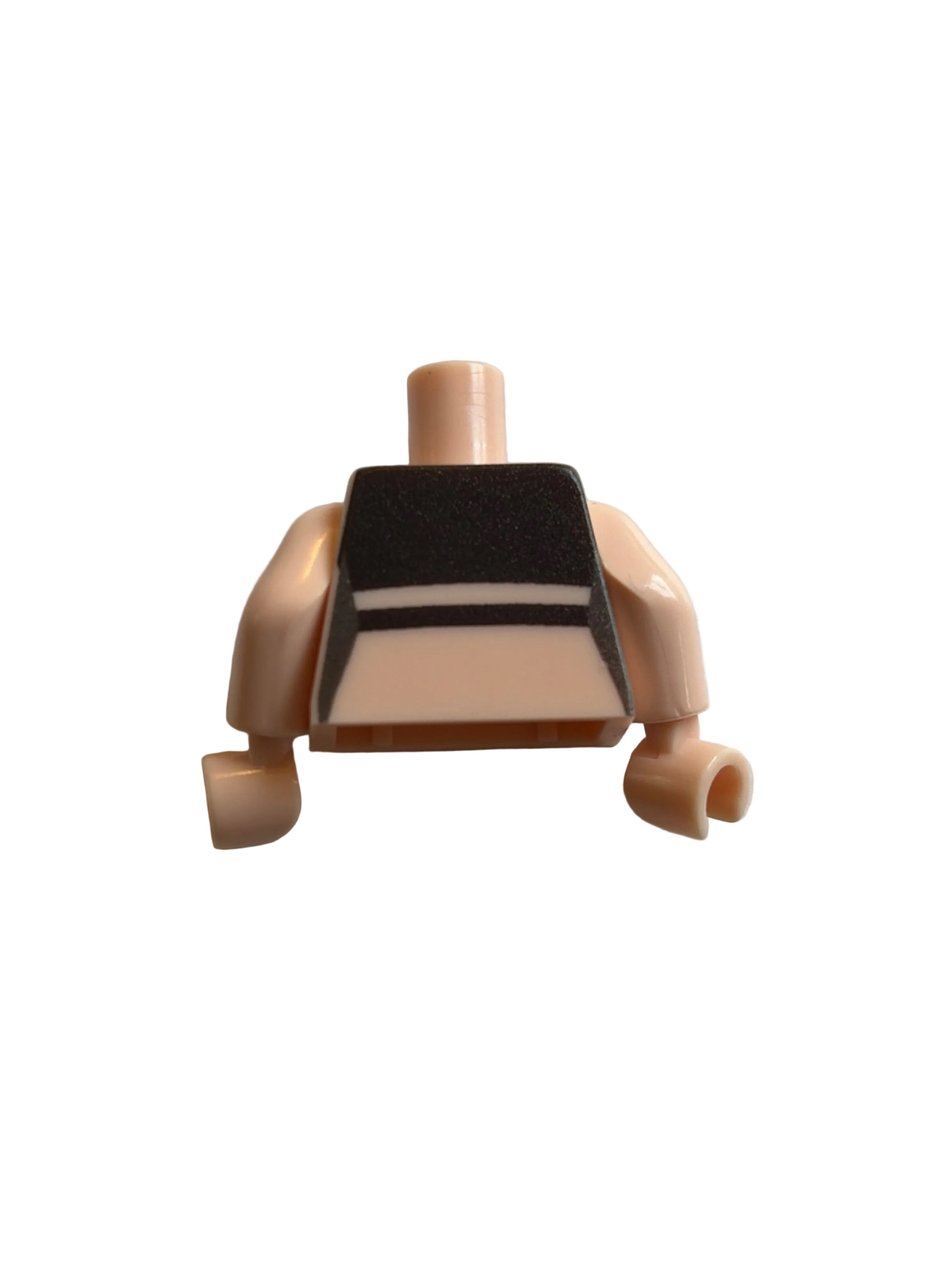 A small plastic toy accessory piece in a pale peach-beige color with a black and white striped rectangular panel, photographed on a plain light background.
