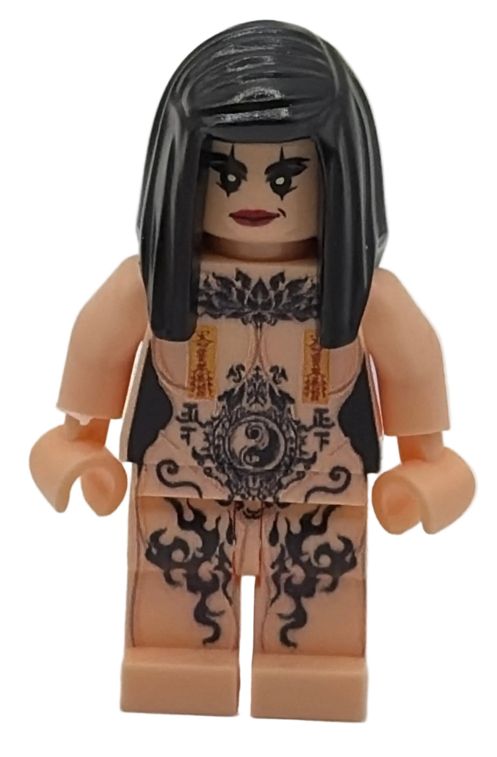 Toy figure with tattoo-like design on a plain background
