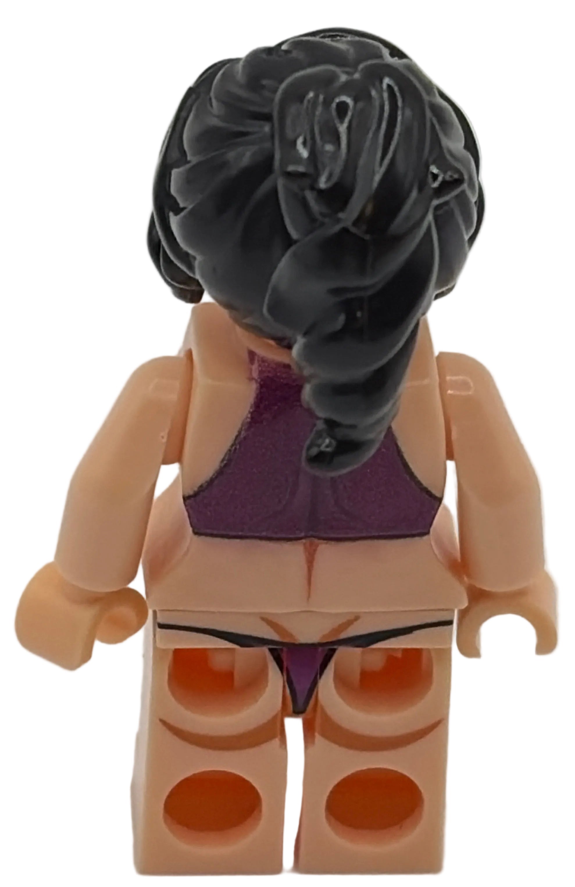 Toy figure with black hair and purple outfit on a white background