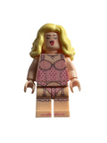 A custom LEGO minifigure with blonde hair, wearing a pink polka-dot lingerie set, photographed against a plain light gray background.