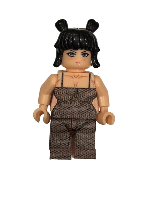 Toy figure with black hair and patterned outfit on a white gray background