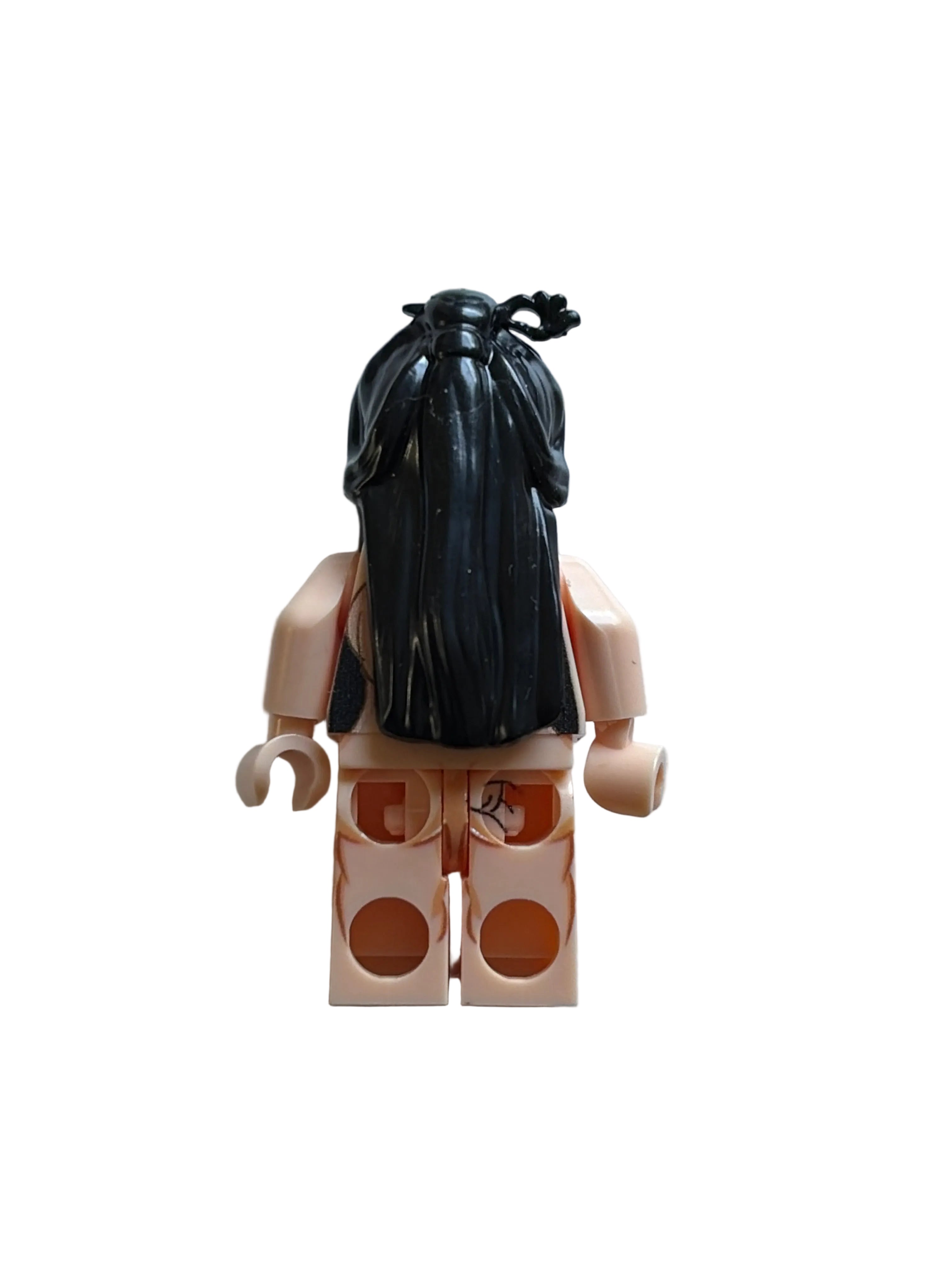 A LEGO minifigure viewed from the back, featuring long black hair, peach skin, and a black top, set against a plain light gray background.