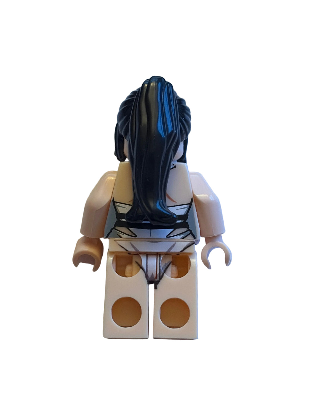 A custom-built LEGO minifigure, likely a female character, featuring long black hair, a beige and black printed bodysuit, and a beige double-socket brick back, shown on a light blue background.