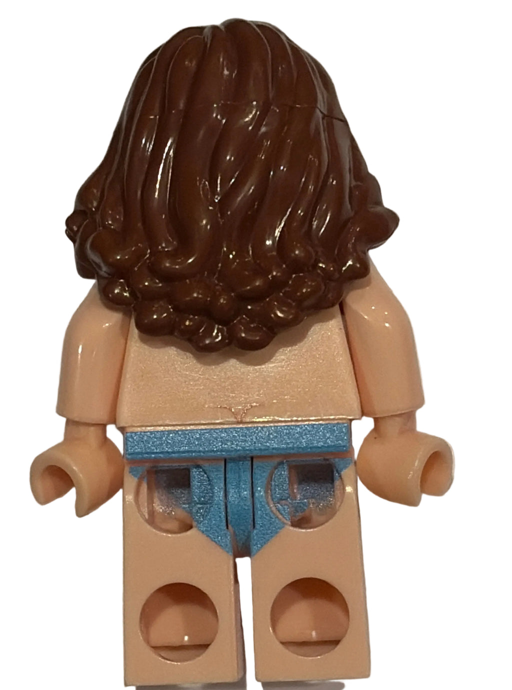 Close-up of a LEGO figure head with brown hair and beige body on a light gray background