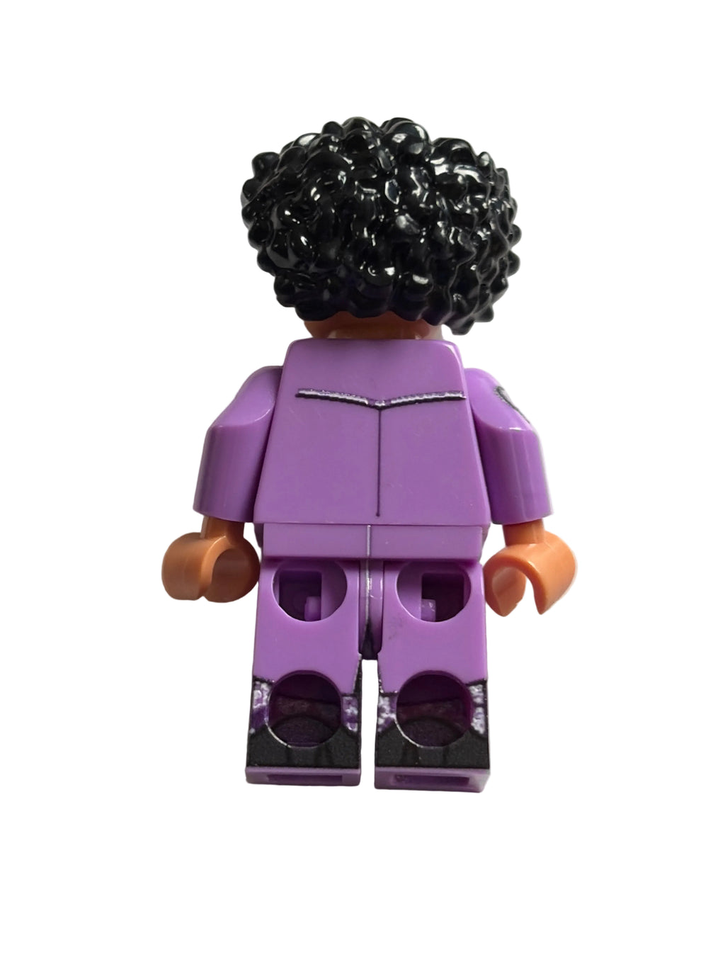 Close-up of a minifigure of Prince with purple torso and black hair on a light gray background