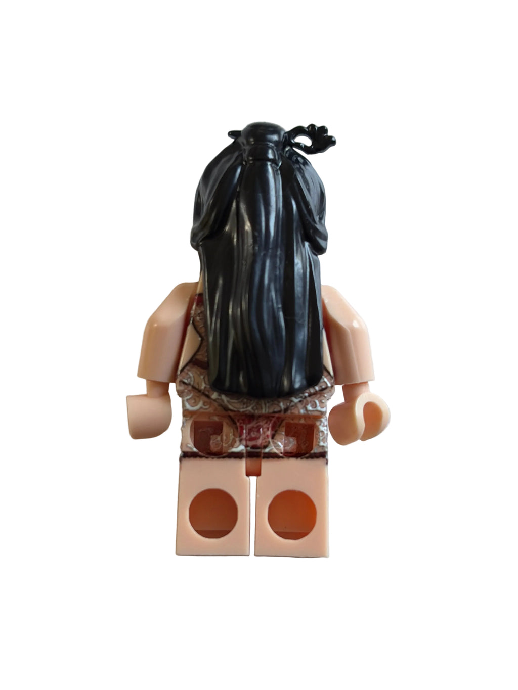 A back view of a custom LEGO minifigure with long black hair, peach skin, and a brown patterned top, standing against a plain light gray background.