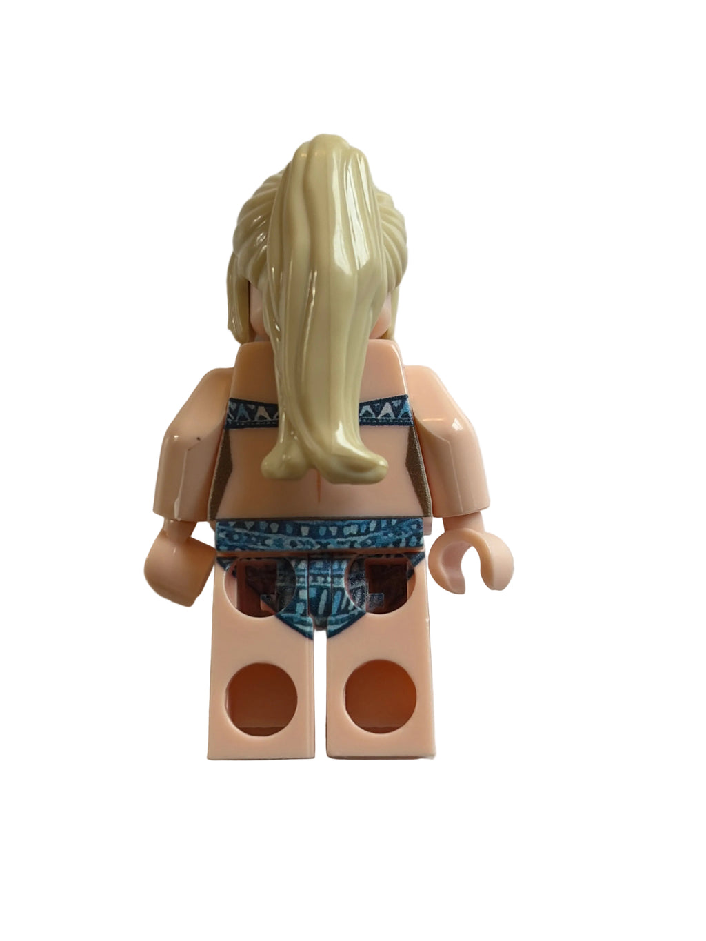 A  minifigure torso with blonde hair, beige skin, and a blue patterned top, shown upside down on a plain white surface.