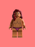A toy minifigure with tan skin, dark red hair, and a purple bikini bottom, shown on a plain light background.