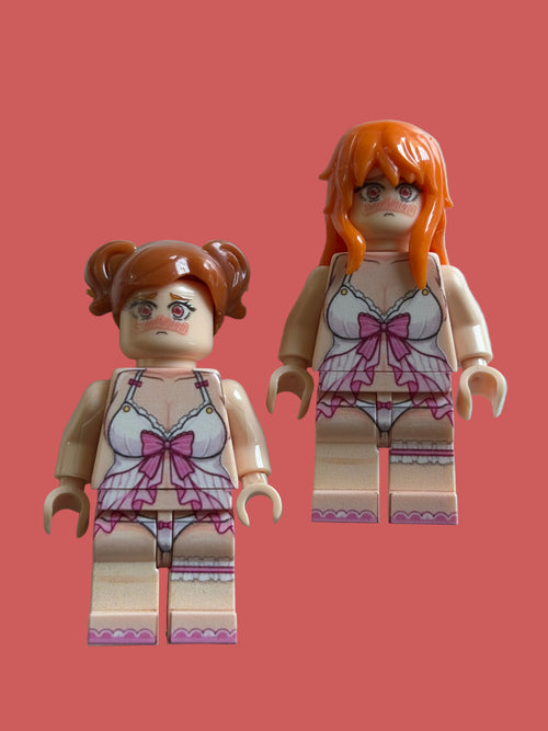Two custom-built toy minifigures with peach skin, orange hair, and lingerie printed on their torsos, standing against a light blue background.