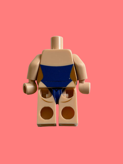 A toy minifigure torso piece with beige skin-tone arms and legs, featuring a blue and tan printed chest design, photographed on a plain light background.