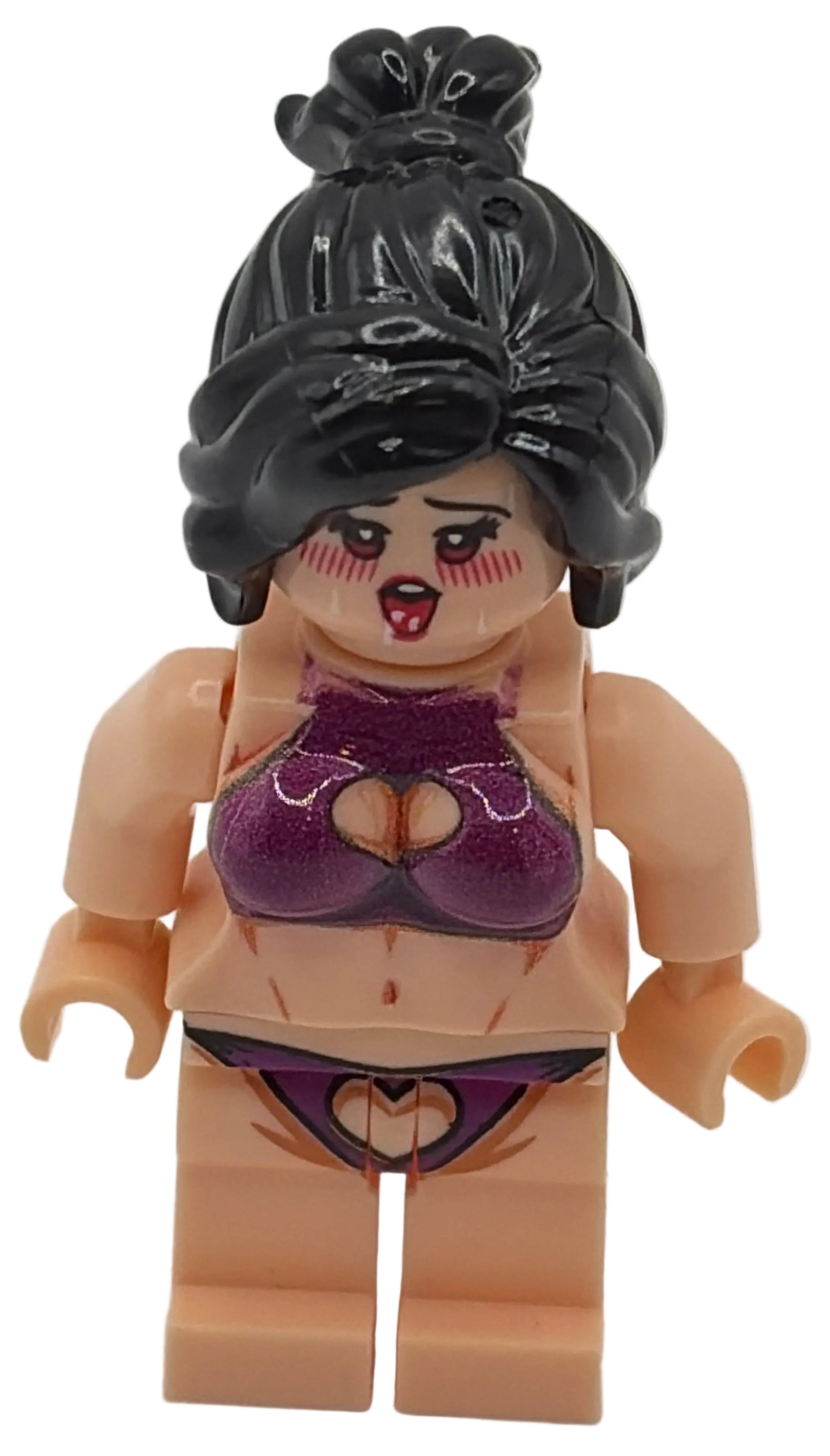Toy figure with a black wig and purple headband on a white background