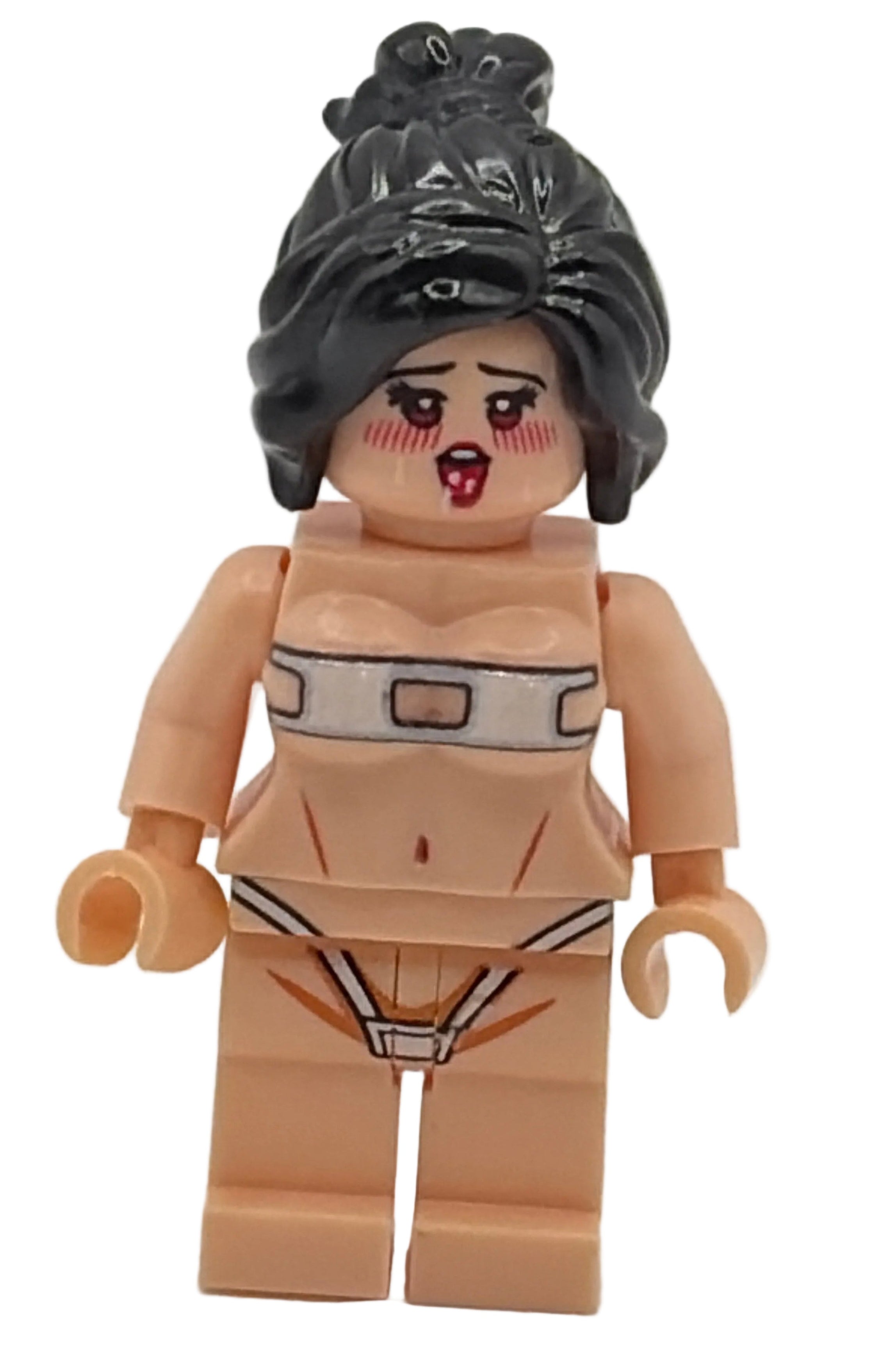 LEGO figure with black hair and beige outfit on a white background