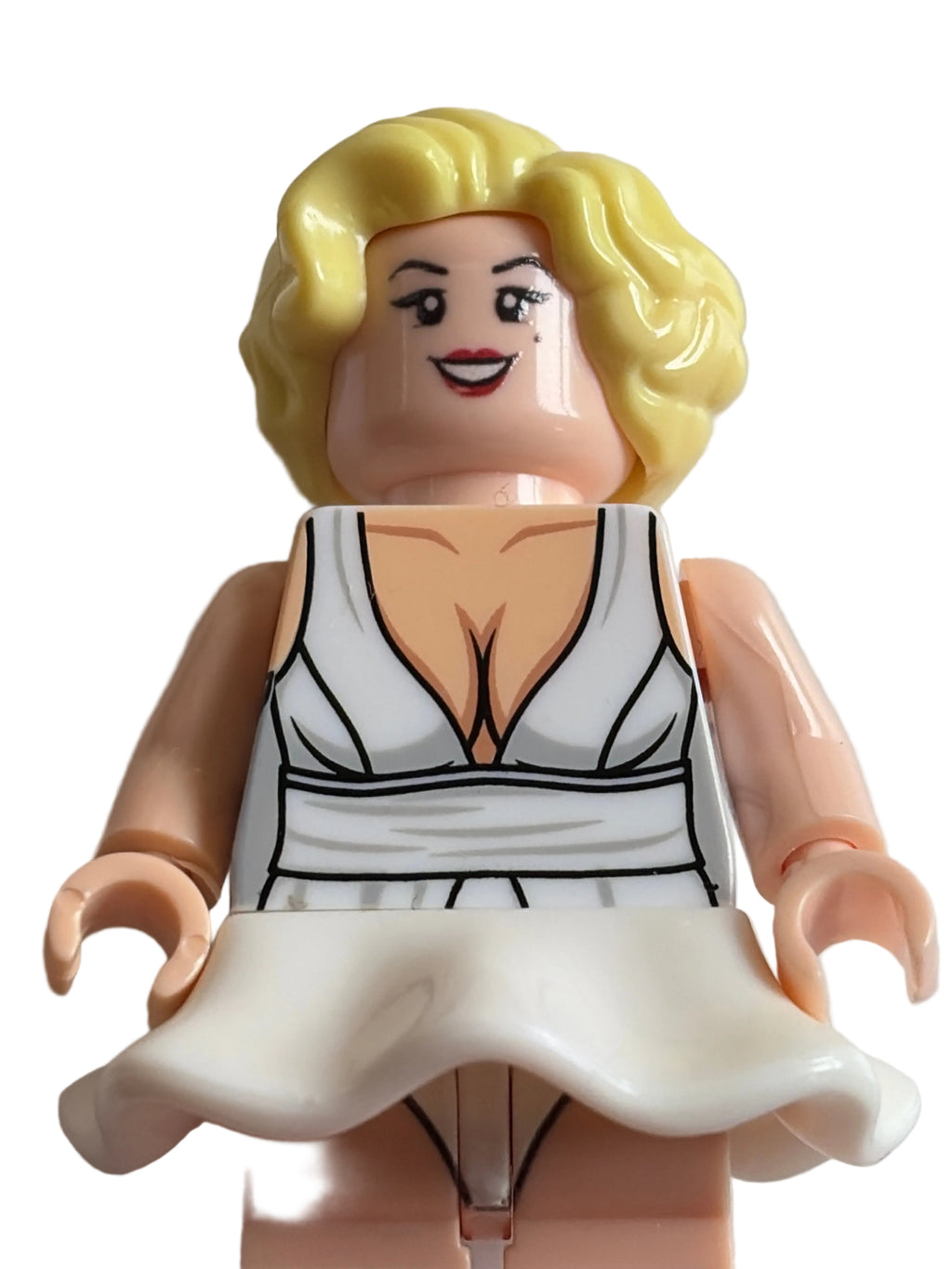 A close-up of a custom-built LEGO-style female minifigure with blonde hair, a printed white and gray sleeveless top, and peach skin tone, shown against a plain light background.