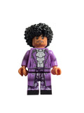 Minifigure of pop star musician Prince with purple outfit and black hair on a light gray background