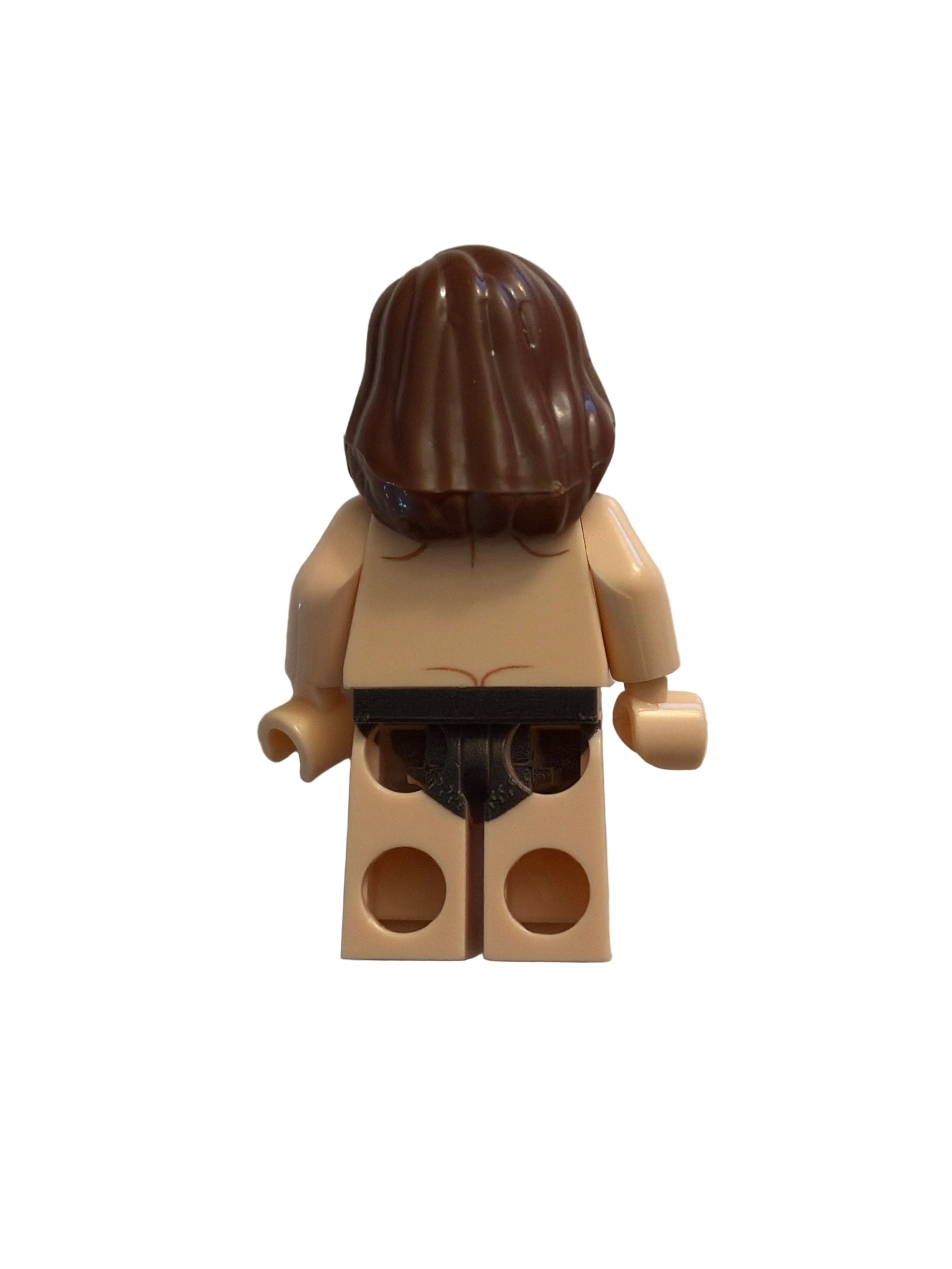 A single topless minifigure torso with a brown hair piece and beige skin-tone legs and arms, photographed on a plain light background.