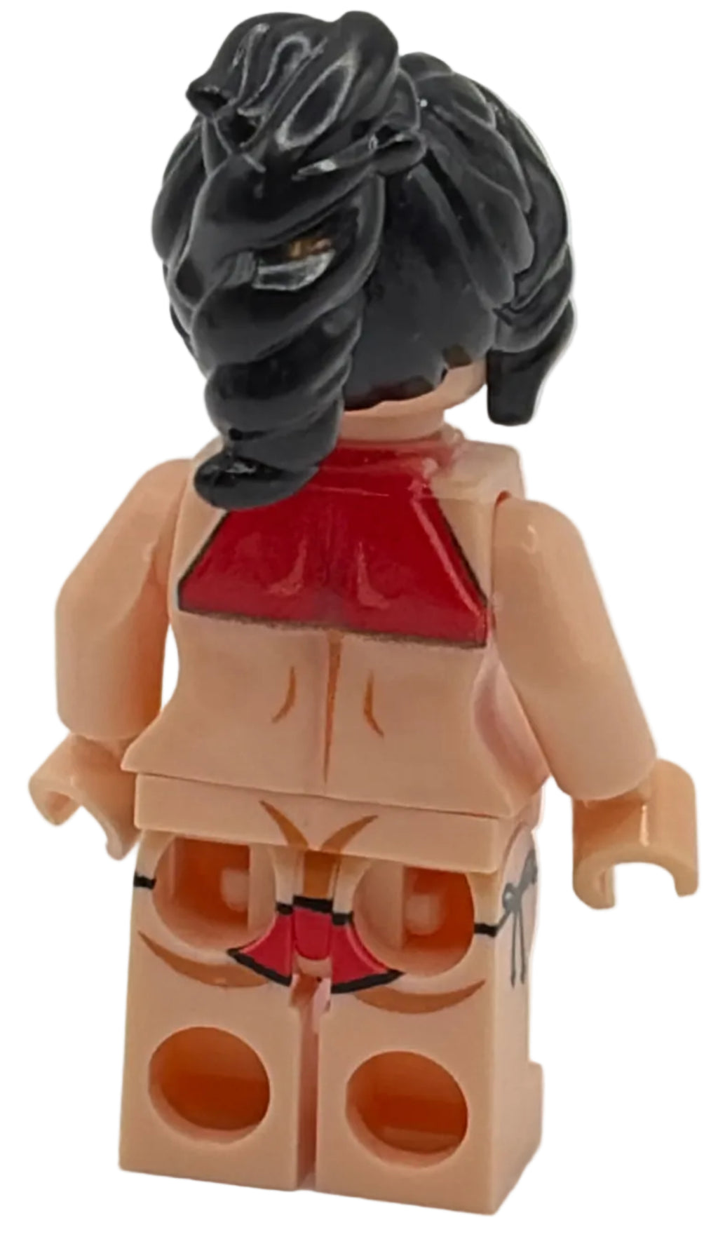 Toy figure with black hair and red outfit on a white background