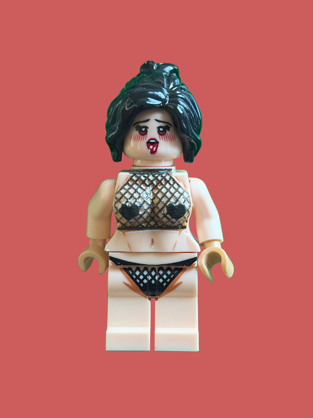 A custom-built toy minifigure with a distressed beige skin tone, black hair, and a mesh black-and-white patterned bikini on a pink background.
