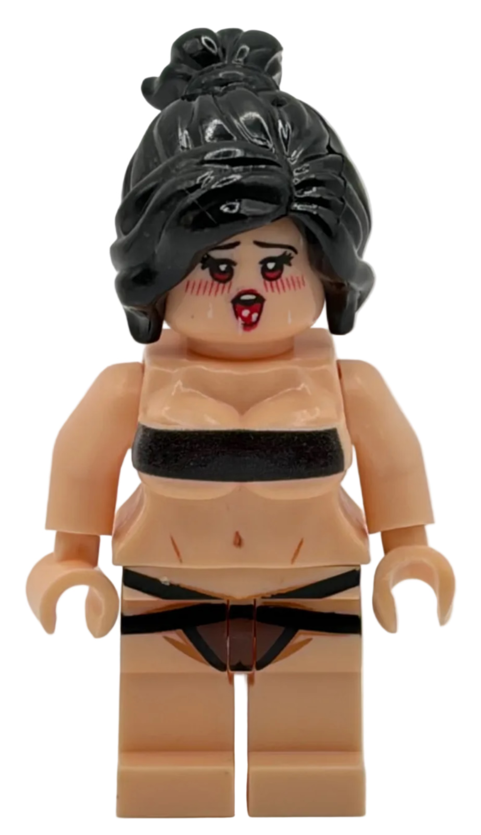Toy figure with black hair and minimal clothing on a white background