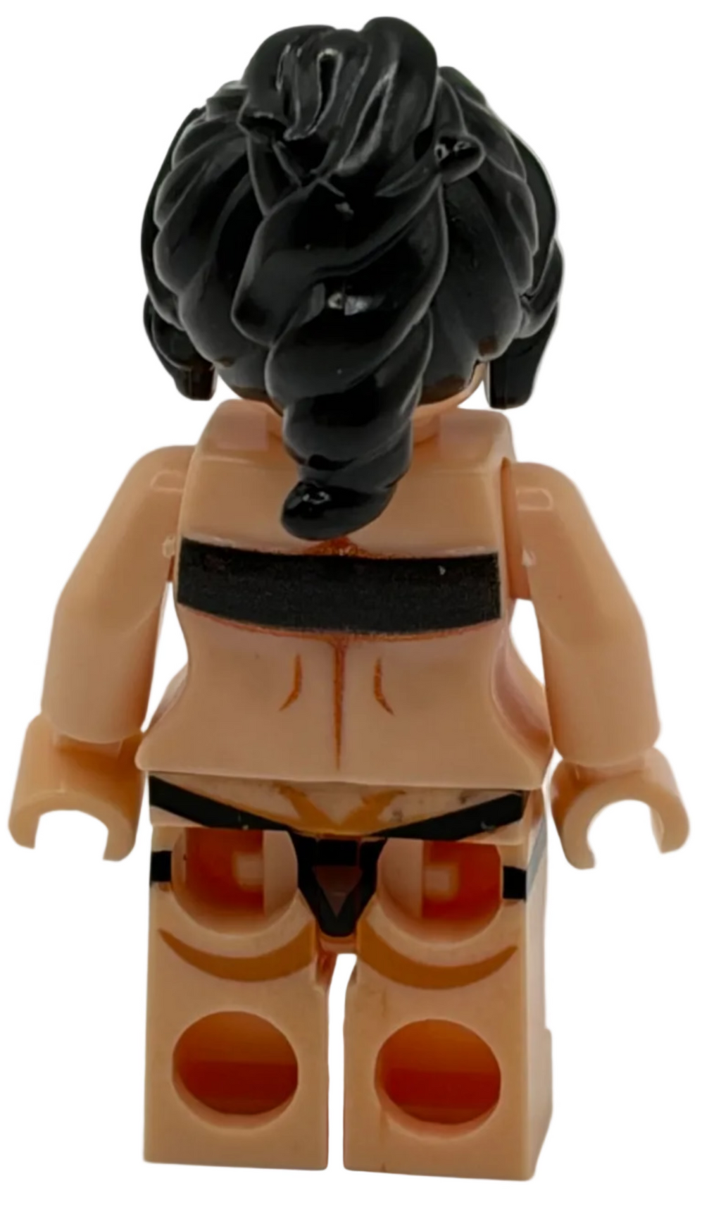 Toy figure with black hair and beige outfit on a white background