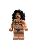 A custom-built female minifigure with black curly hair, a beige skin tone, and printed red and blue bra details on her torso, standing against a plain off-white background.