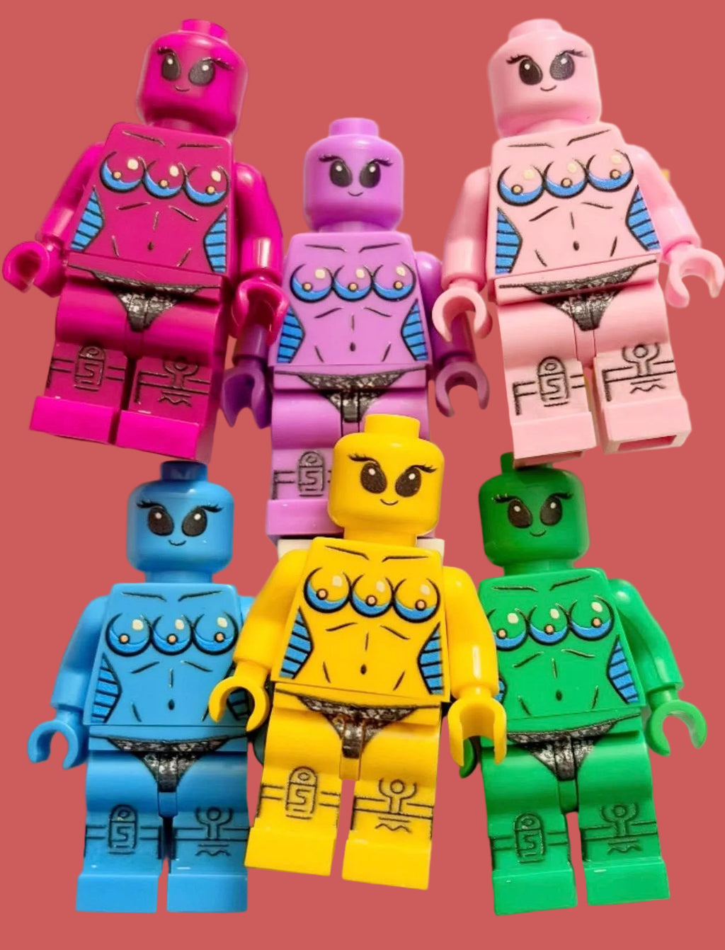 Six toy minifigures arranged in two rows on a plain light background. The figures have stylized muscular torsos with printed nipple details, large eyes, and different body colors: pink, purple, light pink, blue, yellow, and green.